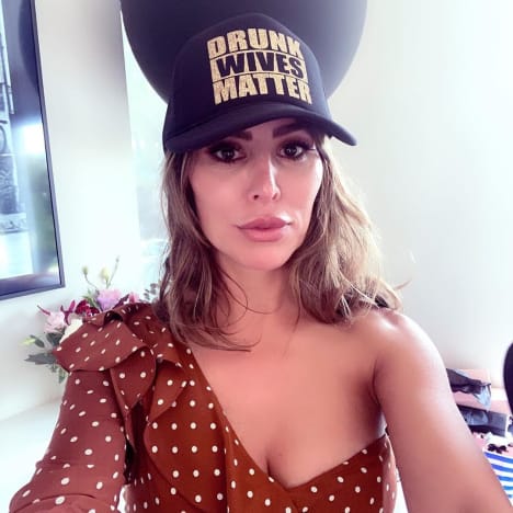 Kelly Dodd in a Drunk Wives Matter Hat