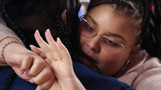 Winter Everett embraces Jah while staring at her ring