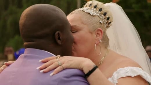 Angela Deem and Michael Ilesanmi kiss as wife and husband