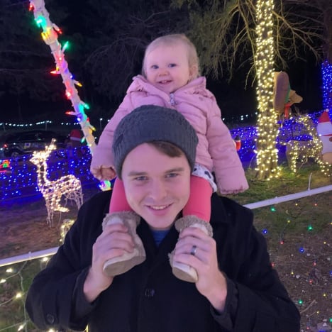 Joe Duggar Holds Baby Addison Among the Lights